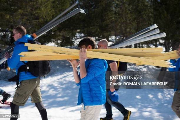 Activists from the French far-right political movement Generation Identitaire and European anti-migrant group Defend Europe carry supplies during an...