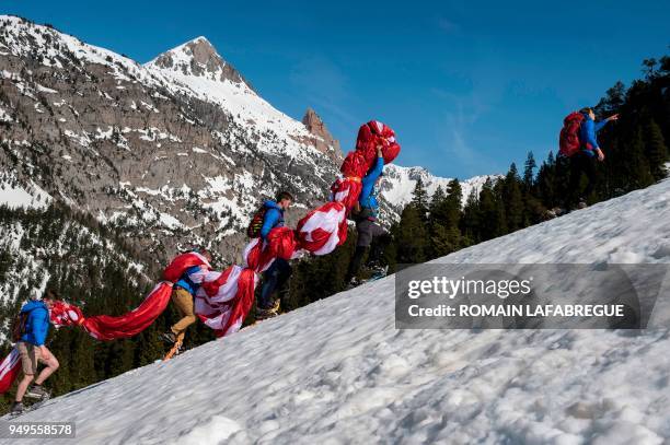 Activists from the French far-right political movement Generation Identitaire and European anti-migrant group Defend Europe carry supplies during an...