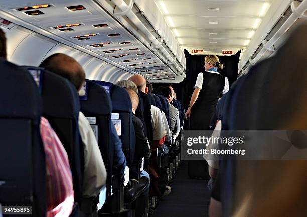 An air stewardess attends to passengers on a Spanair flight from Barcelona to Madrid in Spain, on Monday, May 18, 2009. A Catalana d?Iniciatives and...