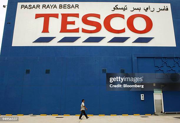 Pedestrian walks past a Tesco Plc hypermarket in Kota Bharu, Kelantan, Malaysia, on Thursday, Sept. 10, 2009. Growing Islamic conservatism in...