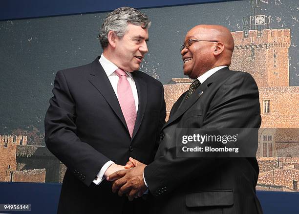 Jacob Zuma, South Africa?s president, right, greets Gordon Brown, U.K. Prime minister, ahead of their bilateral meeting at the G8 summit in L'Aquila,...