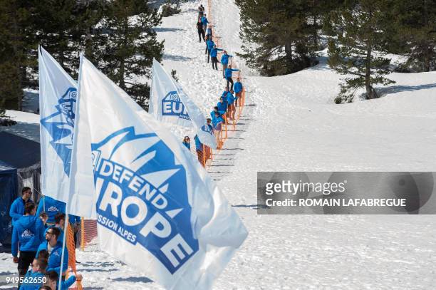 Activists from the French far-right political movement Generation Identitaire and European anti-migrant group Defend Europe erect a barrier during an...