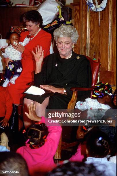 First Lady Barbara Bush attends a Christmas Party for children at the Central Union Mission homeless shelter, Washington DC, December 13, 1989.
