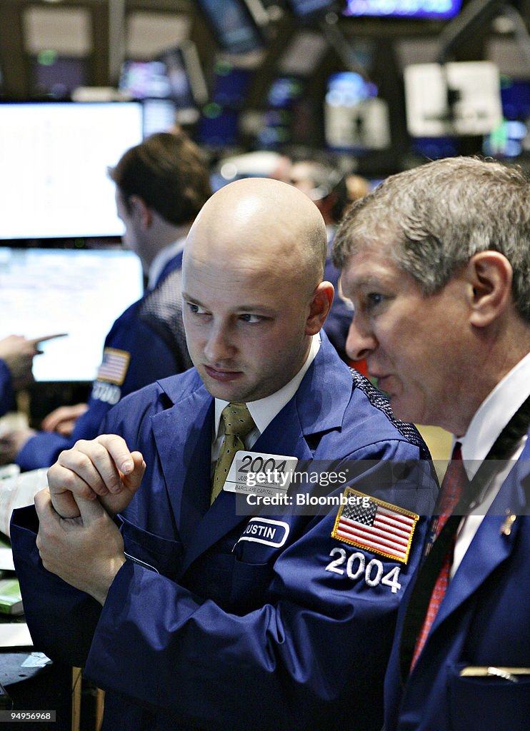 Justin Bohan, left, works on the floor of the New York Stock