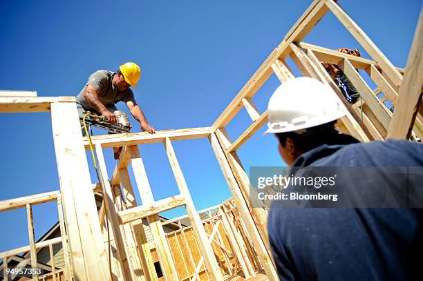 Tomas Martinez, left, frames the second floor of a home under construction in Alpharetta, Georgia, U.S., on Friday, March 20, 2009. The deepening...