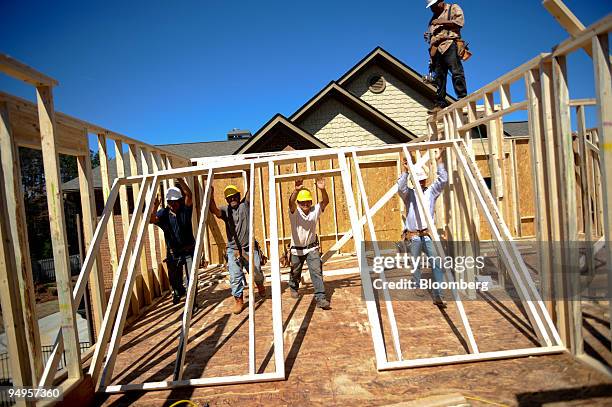 Pre-built wall is lifted into position for a home under construction in Alpharetta, Georgia, U.S., on Friday, March 20, 2009. The deepening economic...