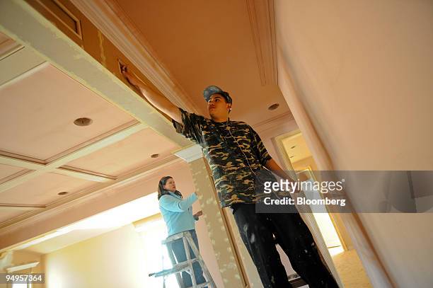Clara Sanchez, left, and Luis Sanchez prepare a new home for painting on in Alpharetta, Georgia, U.S., on Friday, March 20, 2009. The deepening...