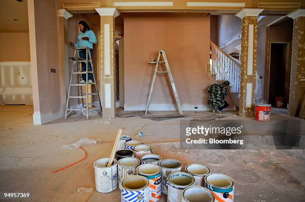 Clara Sanchez, left, and Luis Sanchez prepare a new home for painting on in Alpharetta, Georgia, U.S., on Friday, March 20, 2009. The deepening...