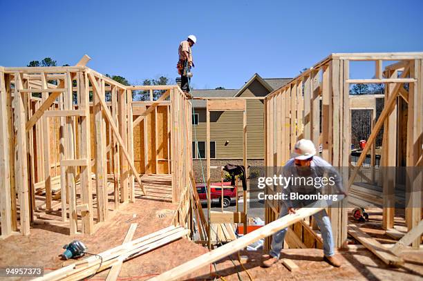 Construction workers build the second floor of a home under construction in Alpharetta, Georgia, U.S., on Friday, March 20, 2009. The deepening...