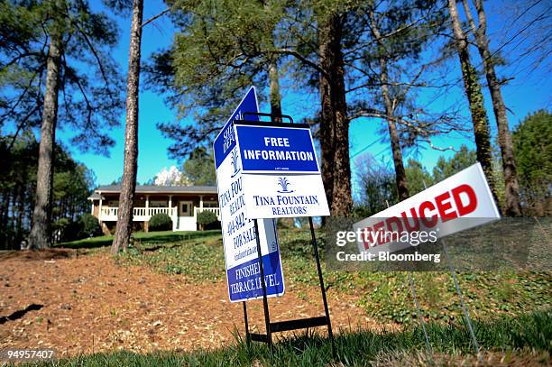 Reduced sign stands outside a home for sale in Smyrna, Georgia, U.S., on Saturday, March 21, 2009. The deepening economic slump prompted the Federal...