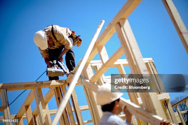 Nicolas Ramos, left, frames the second floor of a home under construction in Alpharetta, Georgia, U.S., on Friday, March 20, 2009. The deepening...