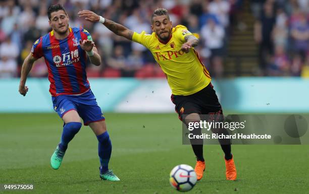 Roberto Pereyra of Watford is challenged by Joel Ward of Crystal Palace during the Premier League match between Watford and Crystal Palace at...