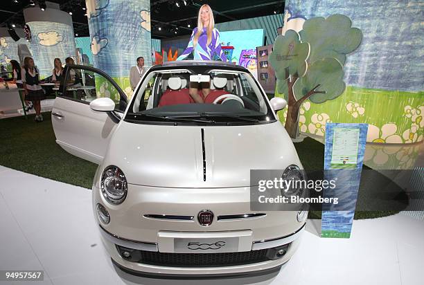 Model poses inside a Fiat 500C Lounge automobile on display on the first press day of the Frankfurt Motor Show, in Frankfurt, Germany, on Tuesday,...