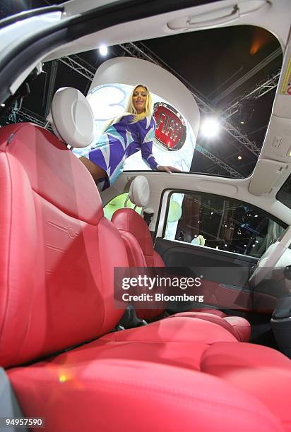 Model poses inside a Fiat 500C Lounge automobile on display on the first press day of the Frankfurt Motor Show, in Frankfurt, Germany, on Tuesday,...