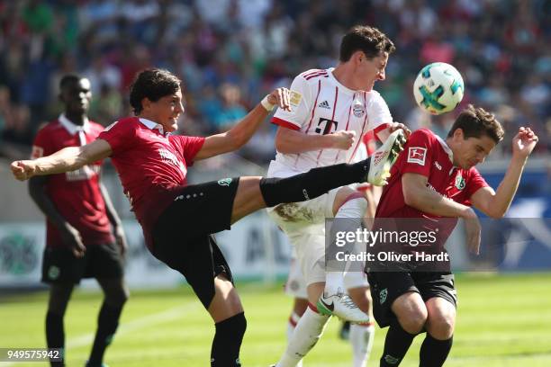 Inola Albornoz and Pirmin Schwegler of Hannover and Sebastian Rudy of Munich compete for the ball during the Bundesliga match between Hannover 96 and...