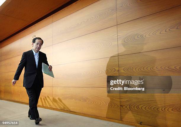 Masaaki Shirakawa, governor of the Bank of Japan, leaves a news conference at the central bank's headquarters in Tokyo, Japan, on Tuesday, June 16,...