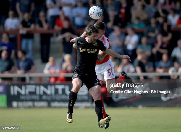Fleetwood Town's Ashley Eastman and Wigan Athletic's Will Grigg contest a header during the Sky Bet League One match at Highbury Stadium, Fleetwood.