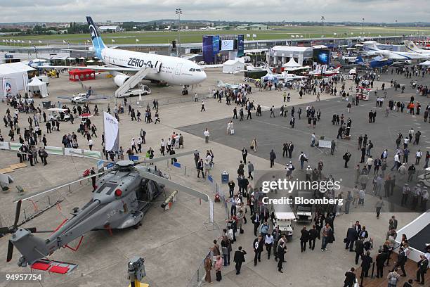 Visitors pass through the Paris Air Show in Le Bourget, France, on Thursday, June 18, 2009. The 48th International Paris Air Show runs from June 15...