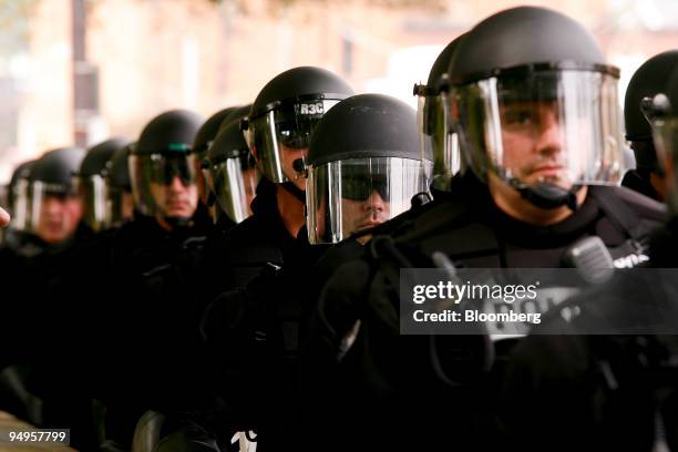 Officers dressed in riot gear monitor protests during day one of the Group of 20 summit in Pittsburgh, Pennsylvania, U.S., on Thursday, Sept. 24,...