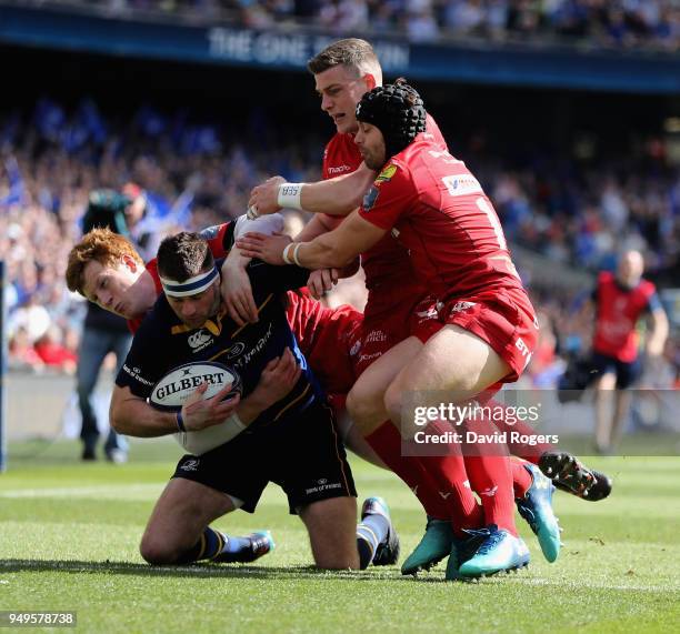 Fergus McFadden of Leinster is tackled by Leigh Halfpenny , Rhys Patchell and Scott Williams during the European Rugby Champions Cup Semi-Final match...