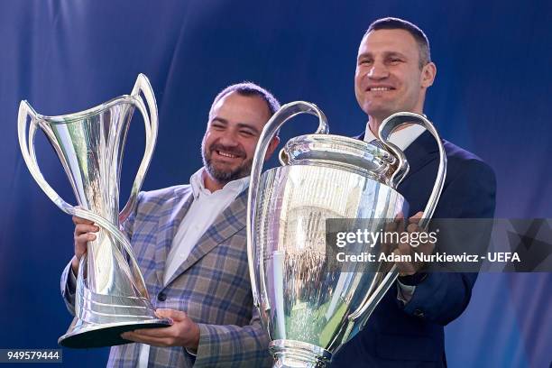 Andriy Pavelko president of the Football Federation of Ukraine and Kyiv Mayor Vitali Klitschko hold cups during the UEFA Champions League Trophy...