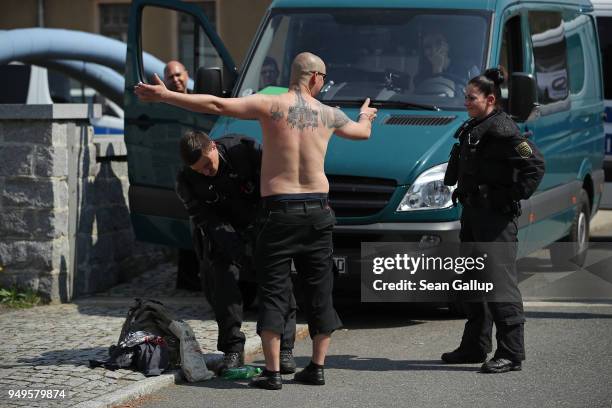 Police check a tattooed participant arriving for a neo-Nazi music fest on April 21, 2018 in Ostritz, Germany. By early afternoon approximately 500...