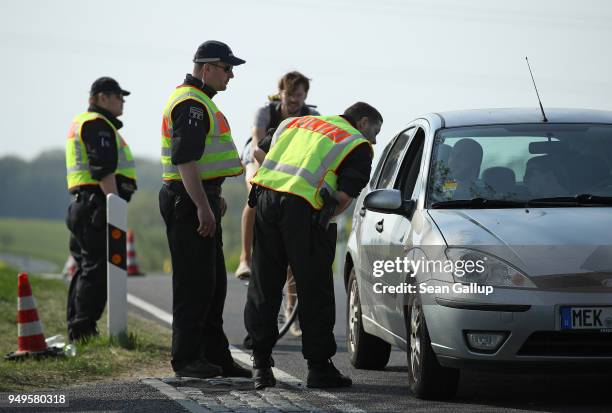 Police check a car arriving at the village outskirts during a neo-Nazi music fest on April 21, 2018 in Ostritz, Germany. By early afternoon...