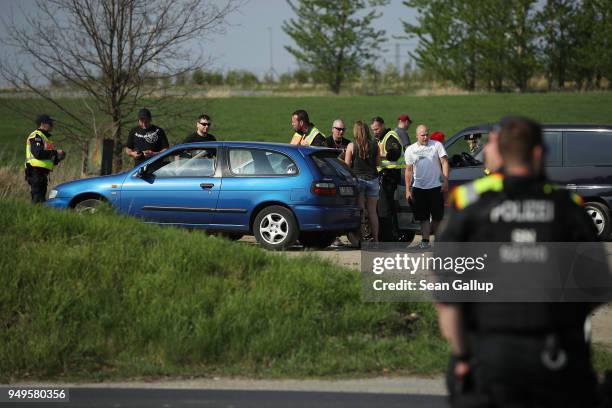 Police check a car arriving at the village outskirts during a neo-Nazi music fest on April 21, 2018 in Ostritz, Germany. By early afternoon...