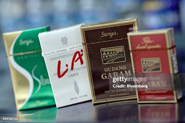 Packages of Djarum Group's L.A. Lights, second left, and PT Gudang Garam cigarettes are arranged for a photograph at a shop in Jakarta, Indonesia, on...
