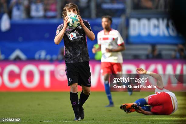 Caglar Soeyuencue of Freiburg holds the ball after a foul on Filip Kostic of Hamburg which leads to a red card for him, during the Bundesliga match...
