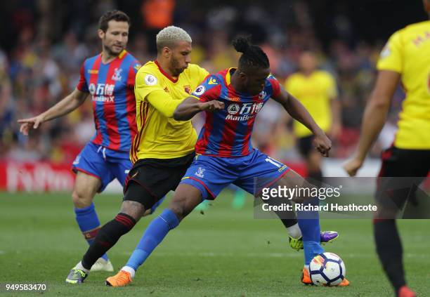 Wilfried Zaha of Crystal Palace is challenged by Etienne Capoue of Watford during the Premier League match between Watford and Crystal Palace at...