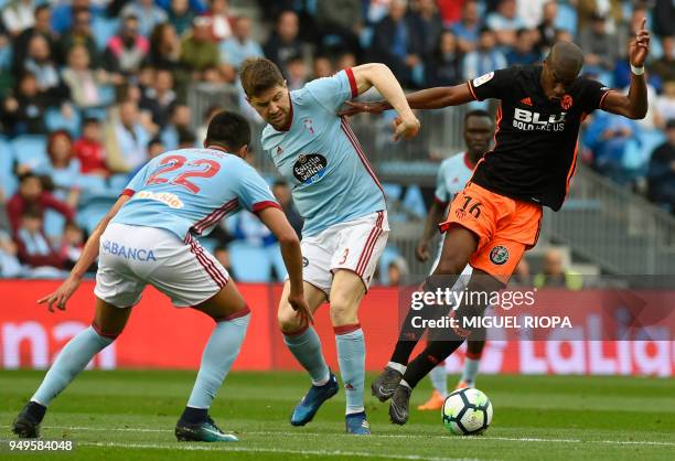 Valencia's French midfielder Kondogbia controls the ball next to Celta Vigo's Argentinian defender Gustavo Cabral and Celta Vigo's Spanish defender...