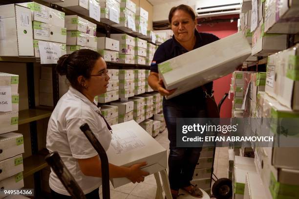 Workers arrange voting material ahead of the upcoming April 22 presidential elections, in Asunción on April 21, 2018. - Opinion polls give the ruling...