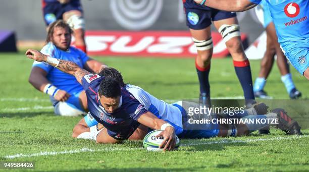 Rebels' Michael Ruru scores a try as he is tackled by Bulls' Lood de Jager during the Super Rugby rugby union match between South Africa's Bulls and...