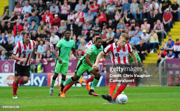 Lincoln City's Elliott Whitehouse scores the opening goal from the penalty spot during the Sky Bet League Two match between Lincoln City and...