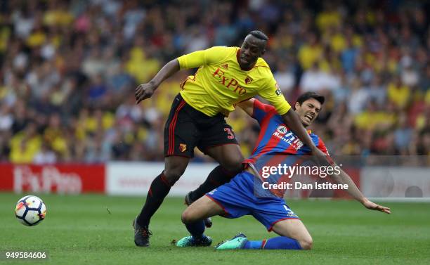 Stefano Okaka of Watford is challenged by James Tomkins of Crystal Palace during the Premier League match between Watford and Crystal Palace at...