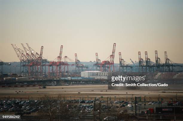 Aerial view of the Port of Newark on a smoggy morning in Newark, New Jersey, with industrial areas, intermodal freight containers, gantry cranes and...