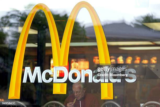 Patron eats French fries at a McDonald's restaurant in Park Ridge, Illinois, U.S., on Wednesday, May 27, 2009. McDonald's Corp., the world's largest...