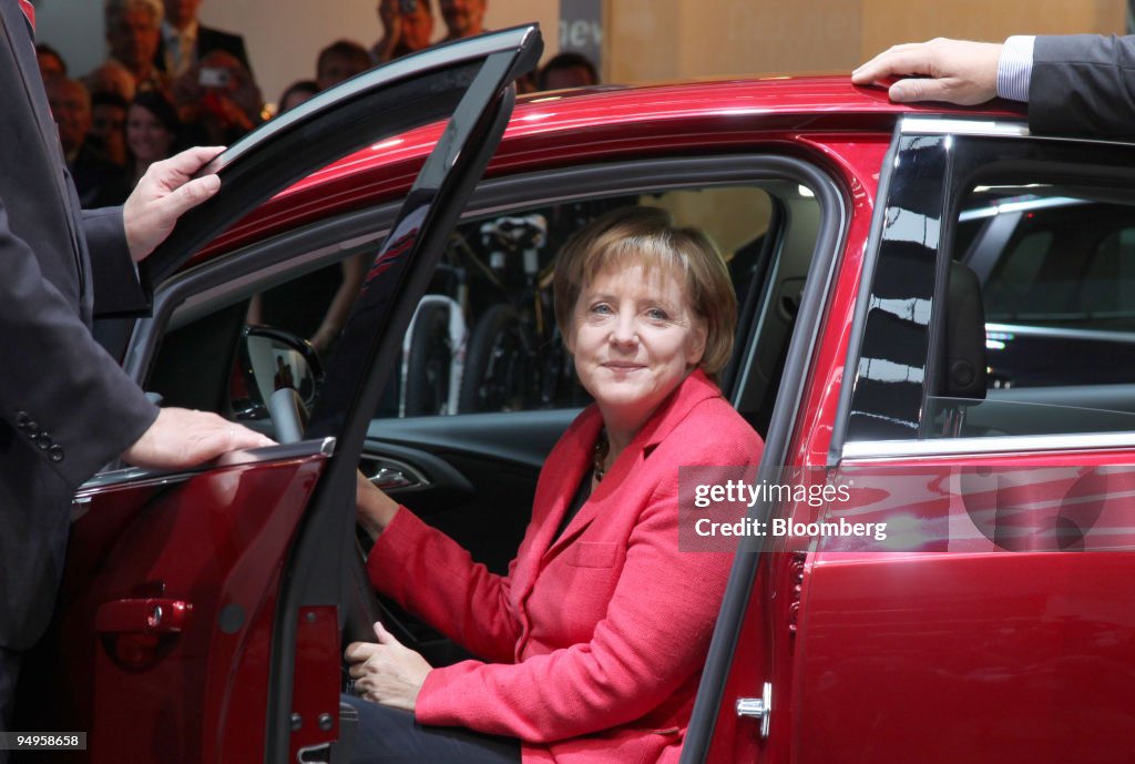 Angela Merkel, Germany's chancellor, tries out the new Opel