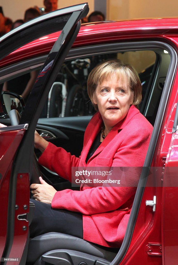 Angela Merkel, Germany's chancellor, tries out the new Opel