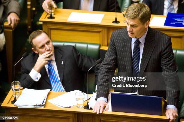 Bill English, New Zealand's finance minister, right, reads the budget as John Key, prime minister, listens in Wellington, New Zealand, on Thursday,...