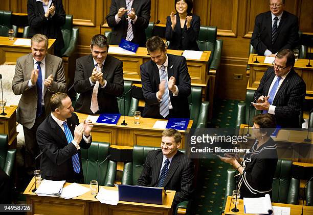 Bill English, New Zealand's finance minister, seated, receives a standing ovation after reading the budget in Wellington, New Zealand, on Thursday,...