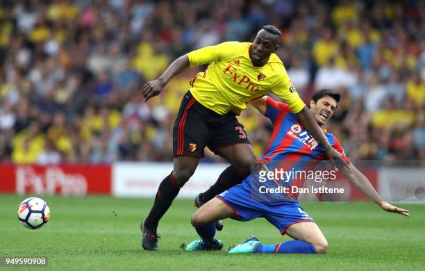 Stefano Okaka of Watford is challenged by James Tomkins of Crystal Palace during the Premier League match between Watford and Crystal Palace at...