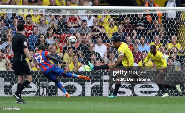 Troy Deeney of Watford clears a shot from Mamadou Sakho of Crystal Palace during the Premier League match between Watford and Crystal Palace at...