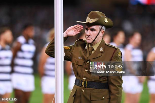 Soldier salutes during the playing of the Last Post last during the round five AFL match between the Port Adelaide Power and the Geelong Cats at...