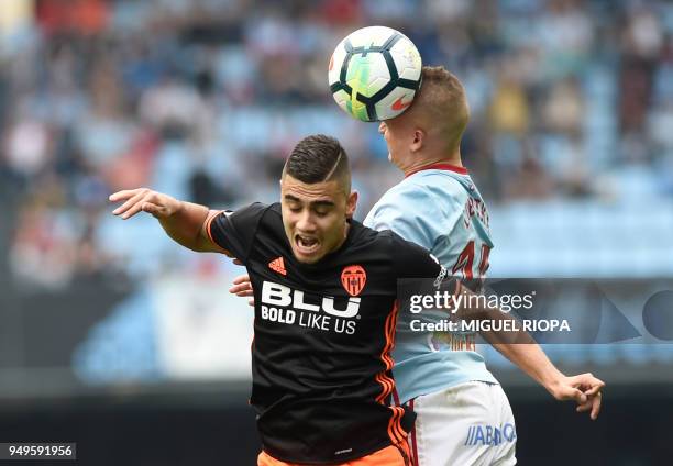 Valencia's Belgian midfielder Andreas Pereira jumps for the ball with Celta Vigo's Slovak midfielder Stanislav Lobotka during the Spanish league...