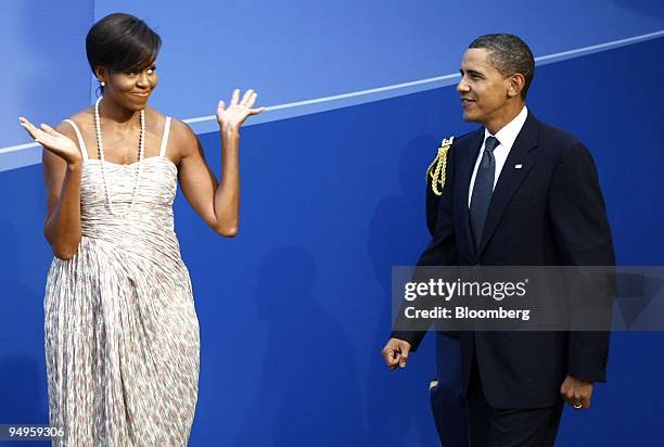 President Barack Obama, right, arrives with U.S. First lady Michelle Obama, to the welcoming dinner for the Group of 20 leaders on day one of the...