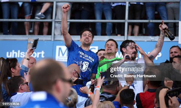 Christian Beck , goalkeeper Jan Glinker and Dennis Erdmann of 1. FC Magdeburg celebrate their Second Bundesliga promotion after the 3. Liga match...