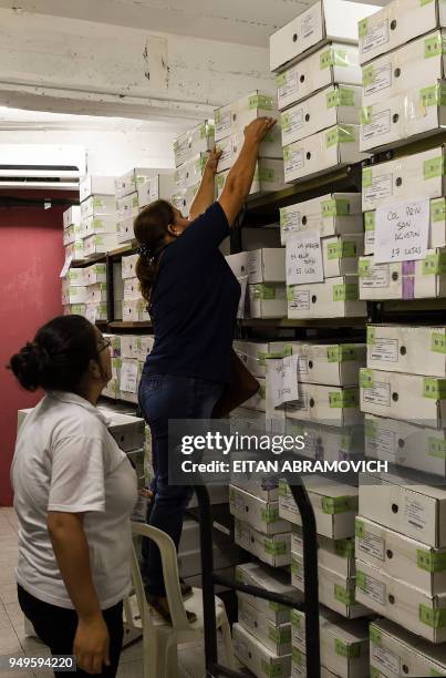 Workers arrange voting material ahead of the upcoming April 22 presidential elections, in Asuncion on April 21, 2018. - Opinion polls give the ruling...