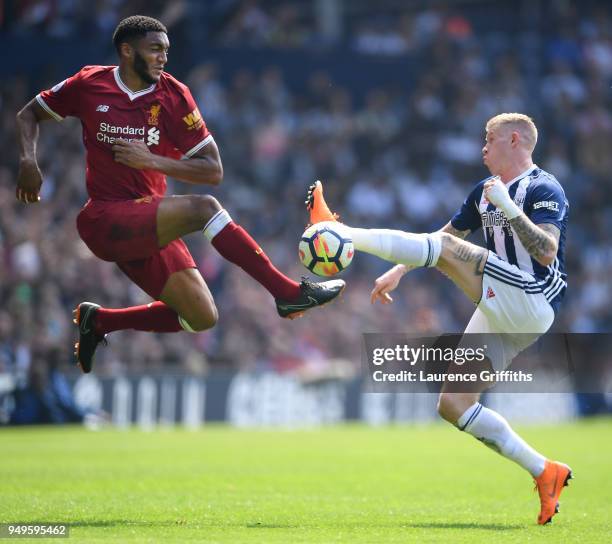 Joseph Gomez of Liverpool rises for the ball under pressure from James McClean of West Bromwich Albion during the Premier League match between West...